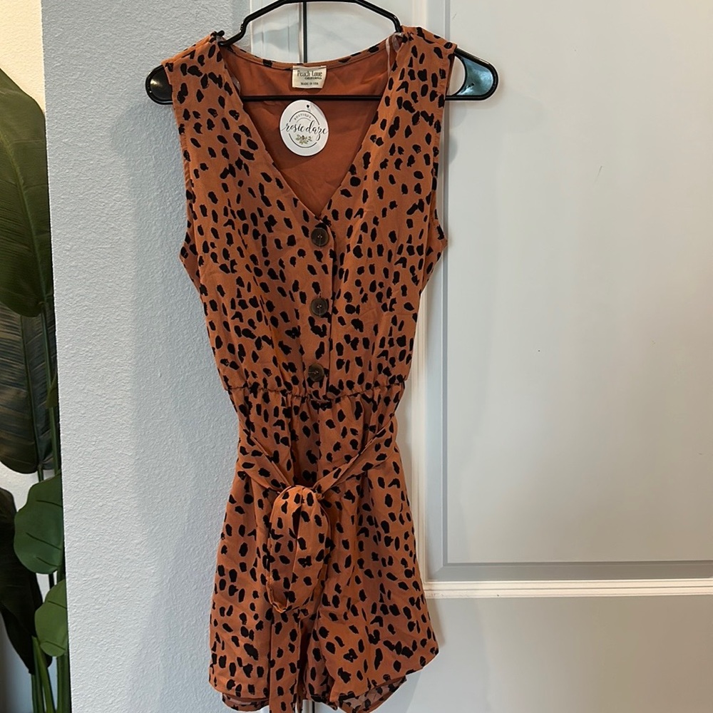 NWT Peach Love Romper. Size Medium. Never worn. Orange tan color.